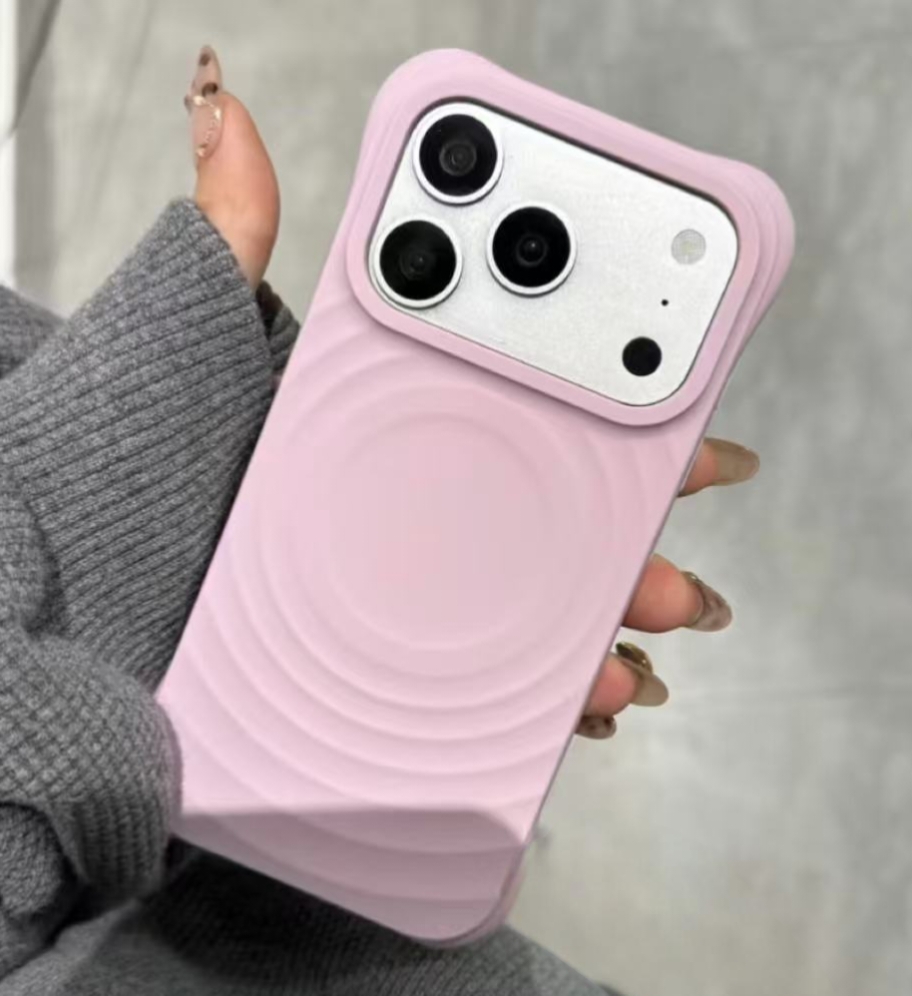 Pink ripple-pattern phone case held in a hand