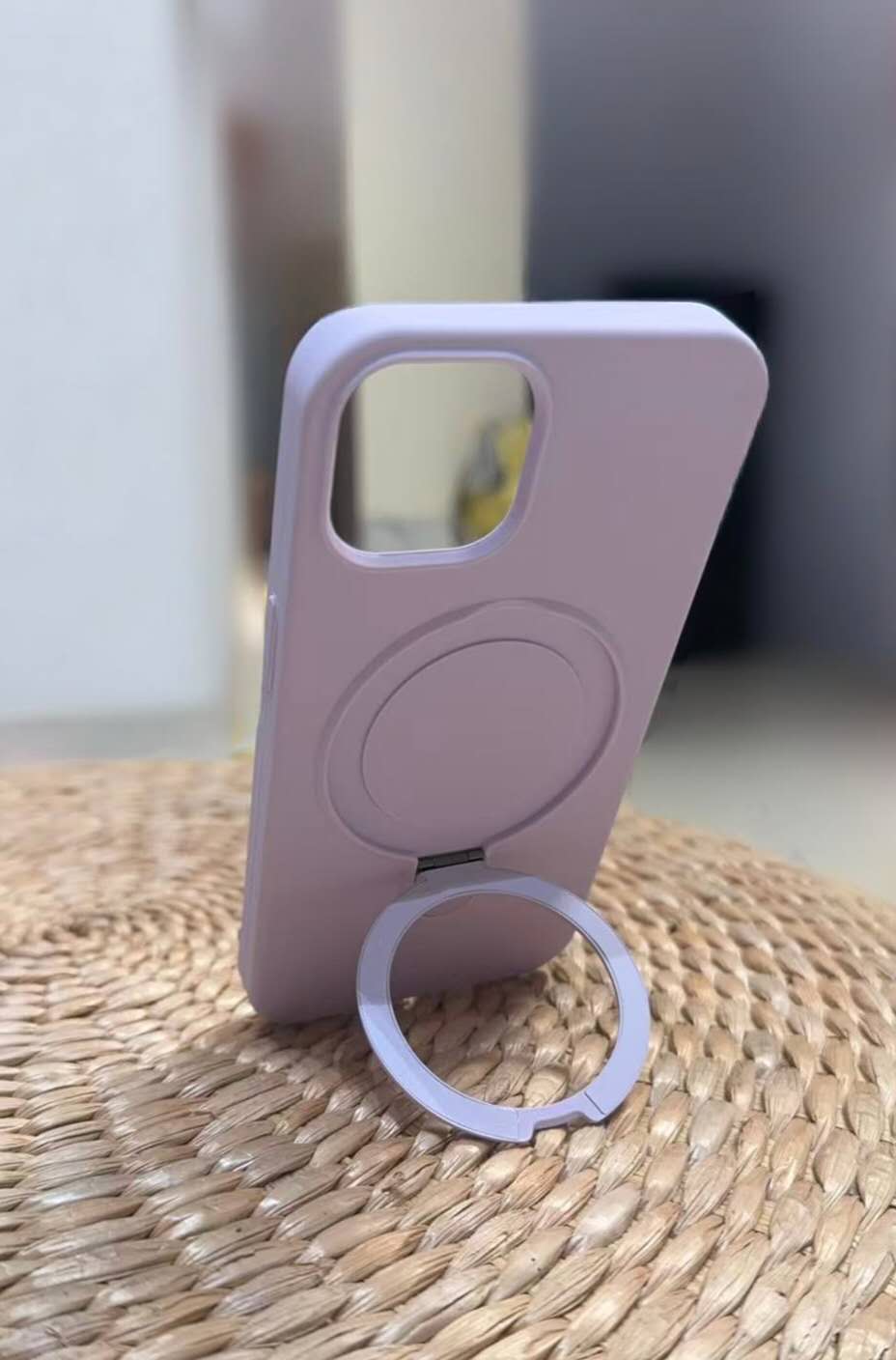 Purple phone case standing upright with its circular ring stand open